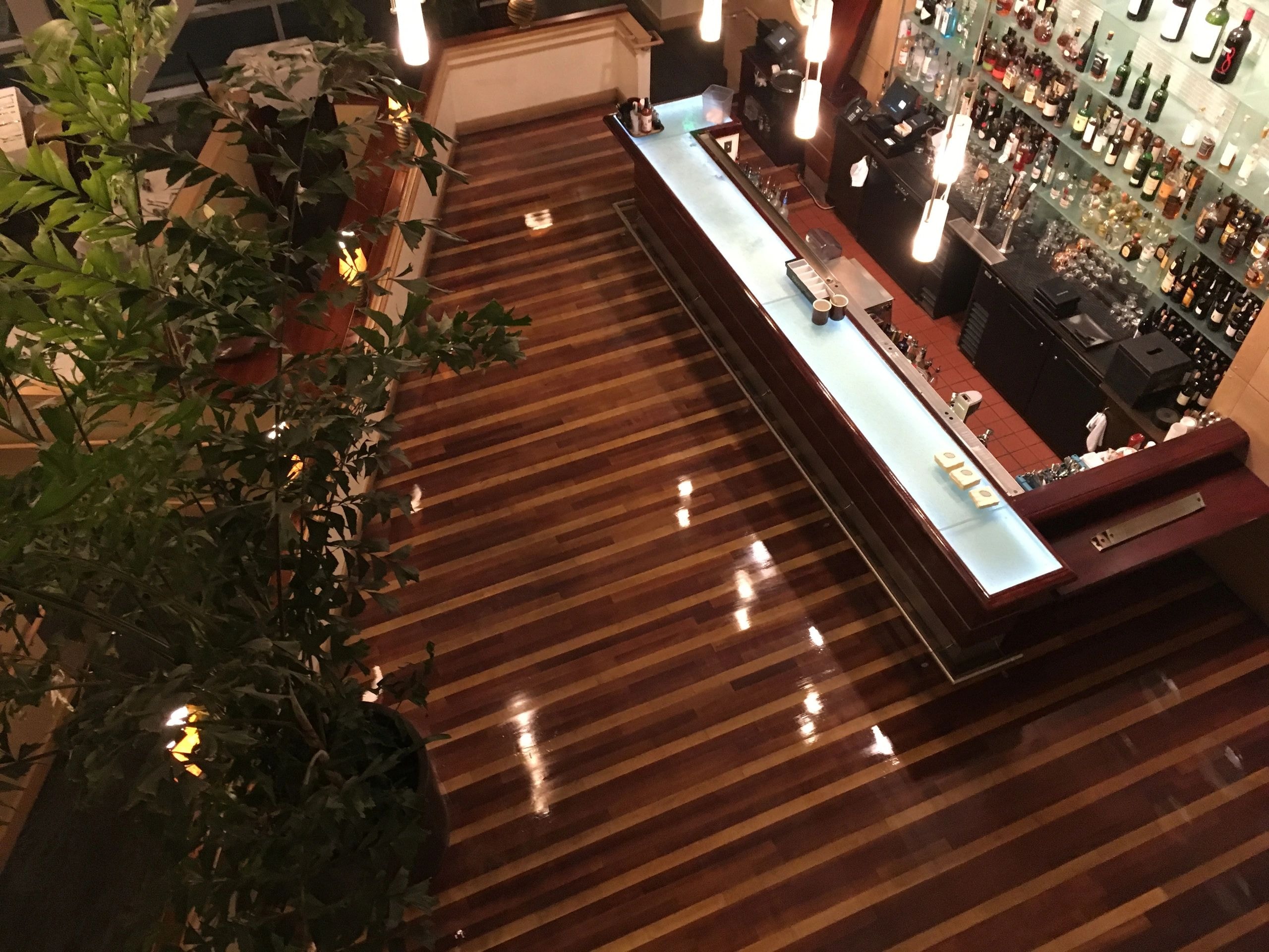 Restaurant hardwood floor installation with bar