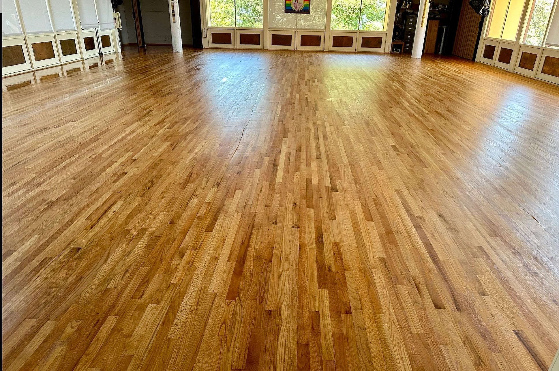 Empty dance studio with refinished wooden floor